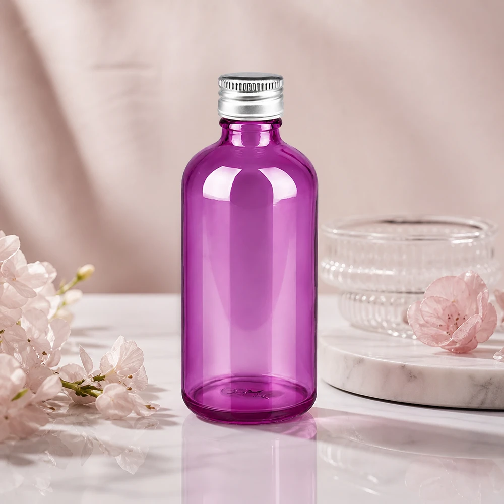 Butelka 100 ml. Zakrętka 11 mm aluminiowo-srebrna w standardzie PurpleLine. UT18/100 Elegancka okrągła szklana butelka o pojemności 100 ml w kolorze fioletowym z wąską szyjką o średnicy 11 mm zapewnia precyzyjne dozowanie.