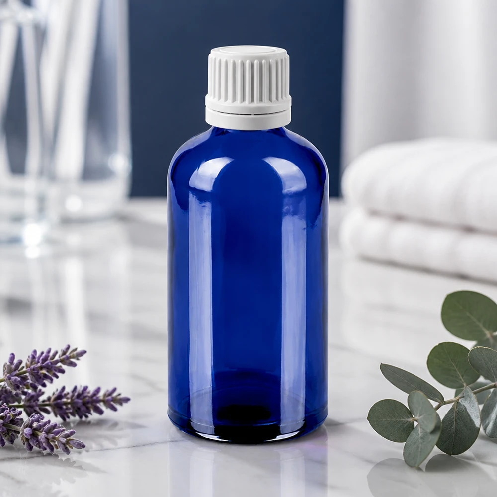 Precyzyjna butelka z kroplomierzem 100 ml wykonana z wytrzymałego niebieskiego szkła z białą zakrętką zabezpieczającą przed dziećmi