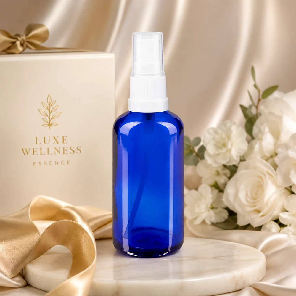 Szklana butelka o pojemności 50 ml w kolorze kobaltowym z białą głowicą rozpylającą na tle eleganckiego pudełka prezentowego