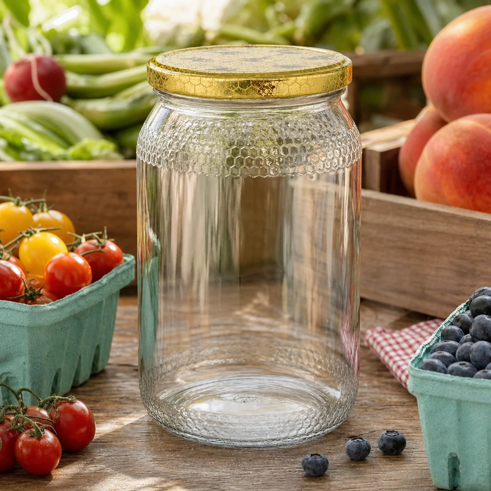 1260g Honigglas + BasicSeal Deckel Bienenwabe UNiTWIST 900 ml pusty słoik miodu ze złotą pokrywką w kształcie plastra miodu pomiędzy świeżymi owocami i warzywami na drewnianym stole kuchennym