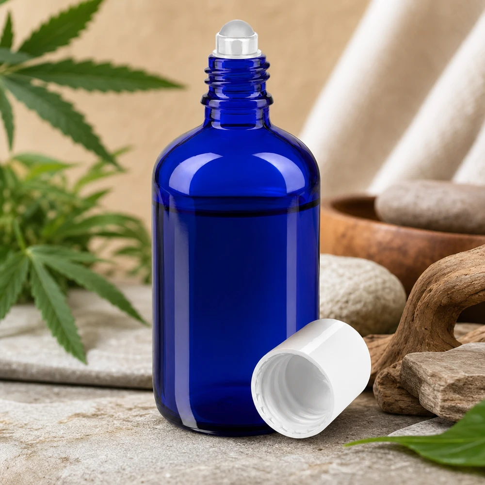 Niebieska szklana buteleczka apteczna z kulką o pojemności 100 ml, z naturalnymi kamieniami i liśćmi konopi