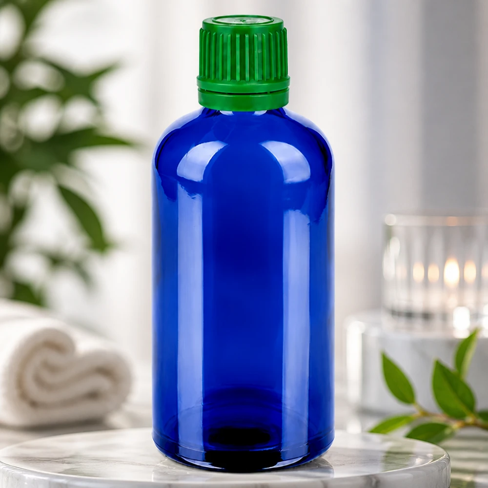 Kompaktowa szklana butelka o pojemności 100 ml w kolorze niebieskim z zieloną nakrętką zapewnia precyzyjne dozowanie i bezpieczne przechowywanie.