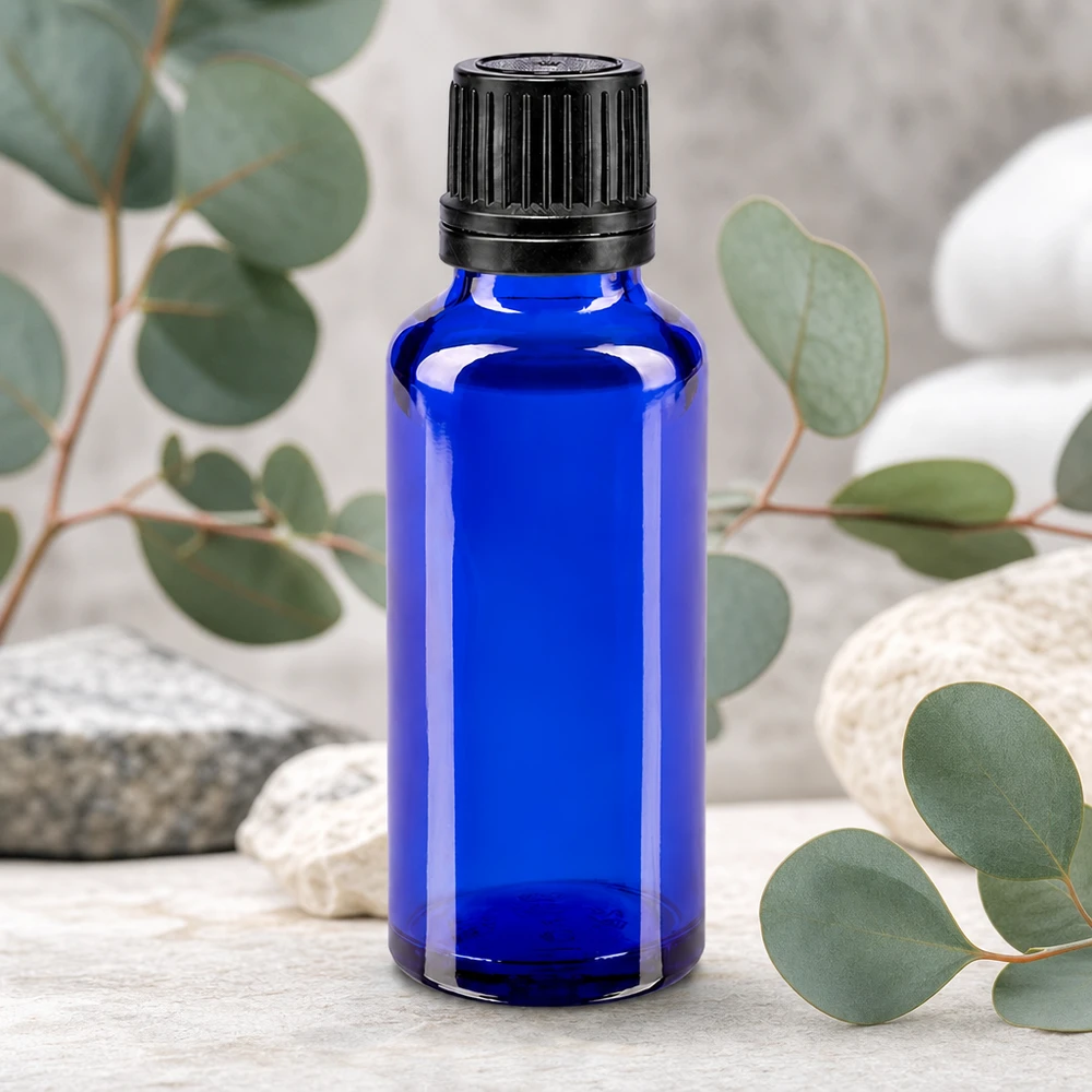 Butelka apteczna niebieska 30ml zakrętka czarny nalewak r. OV Mała niebieska szklana buteleczka o pojemności 30 ml z czarnym zamknięciem zabezpieczającym przed manipulacją, z gałązkami eukaliptusa